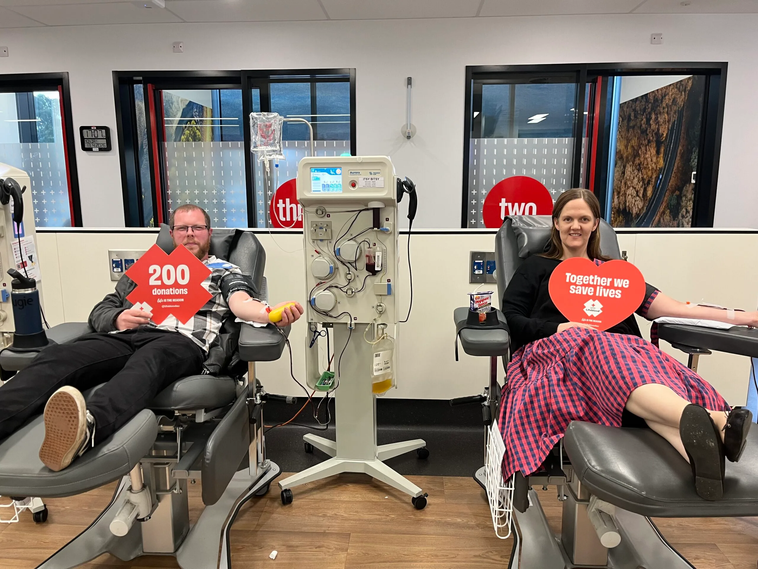 man and woman donating blood