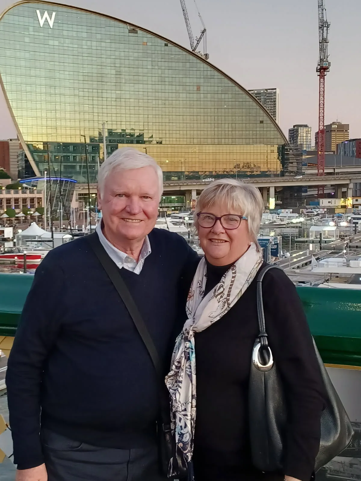 man and woman pose for photo outside