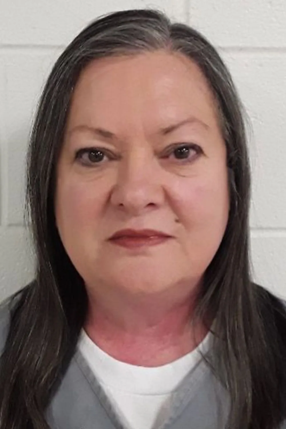 woman in grey jumpsuit mugshot