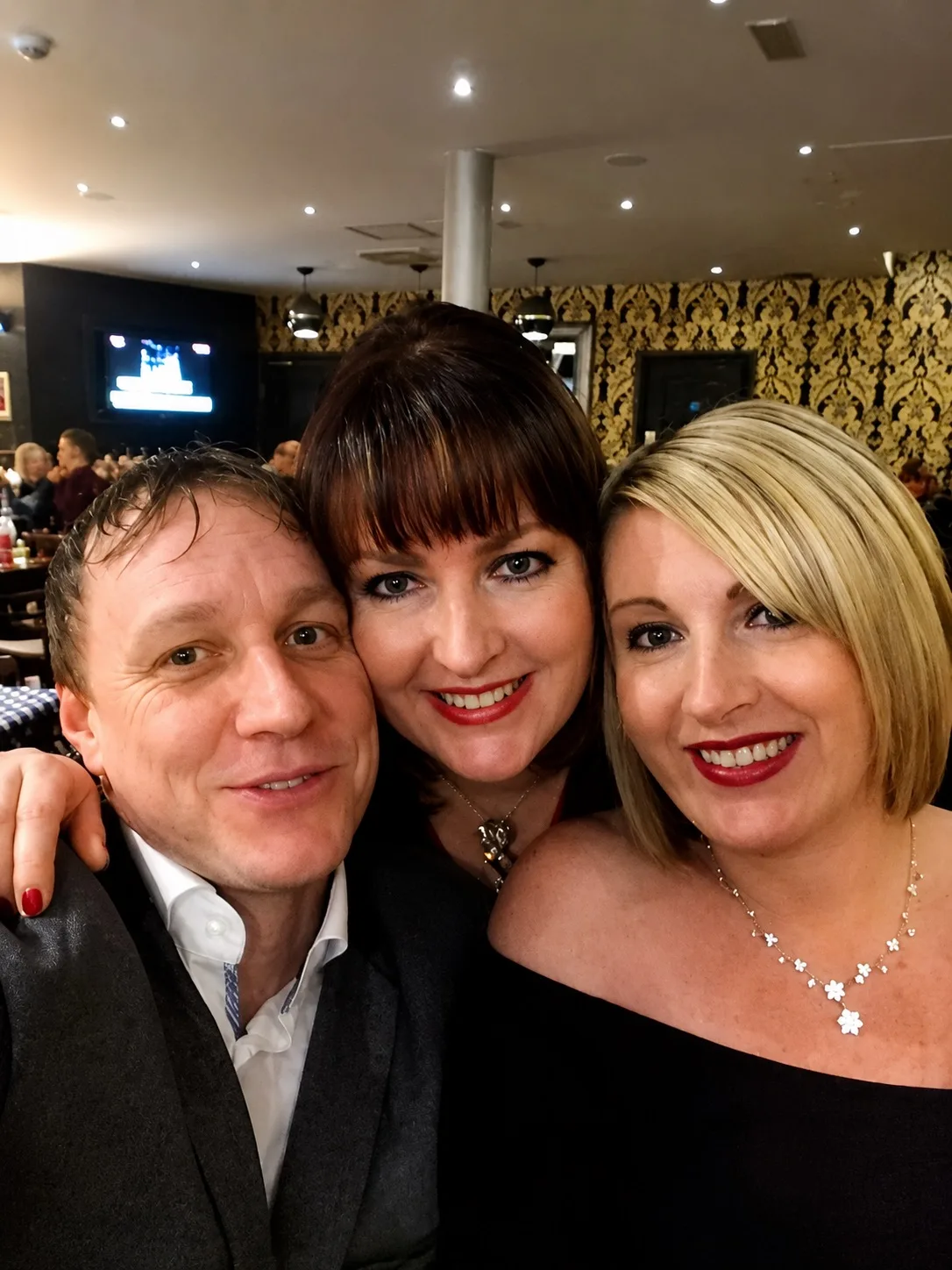 dressed up sisters selfie with man