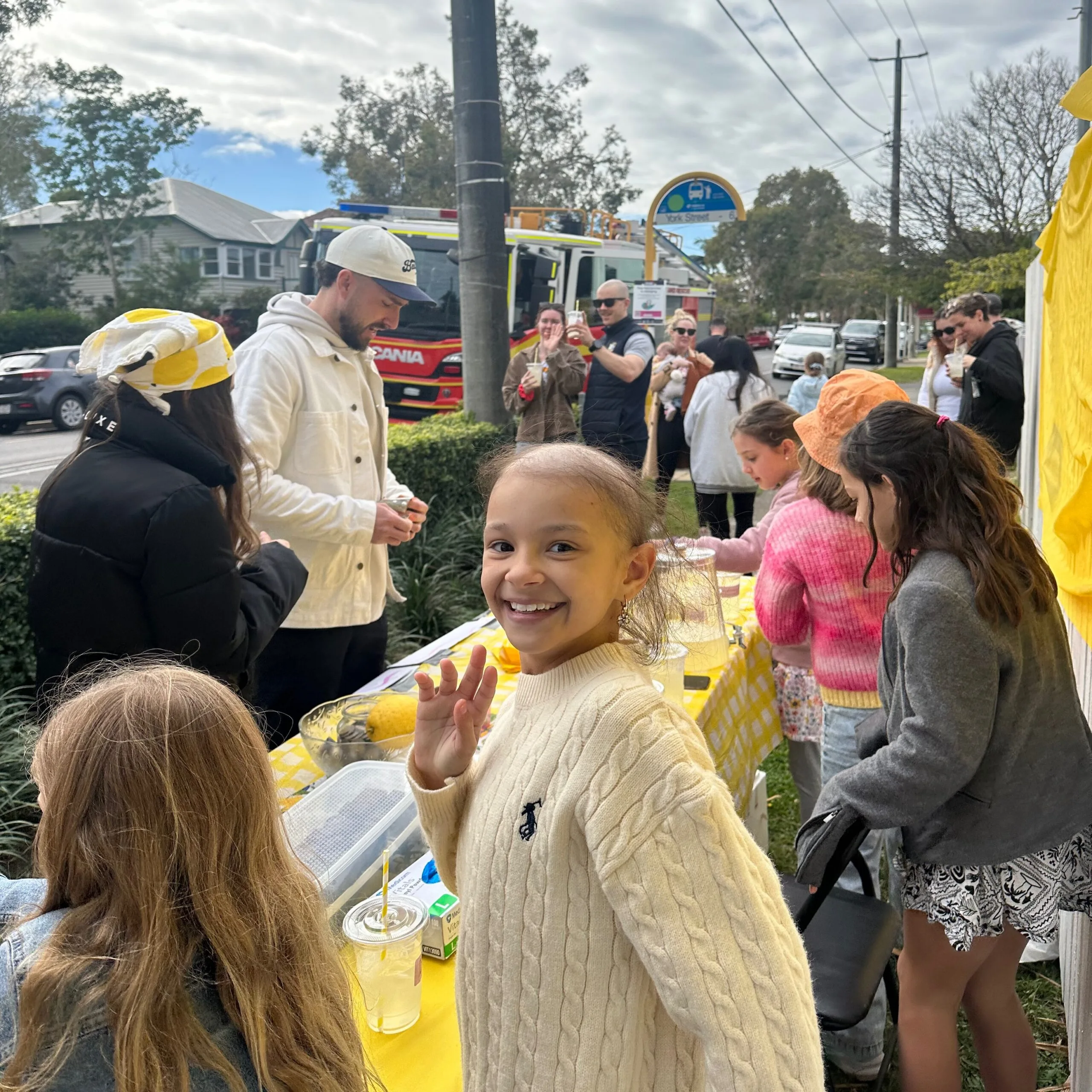 people gathered around lemonade stall