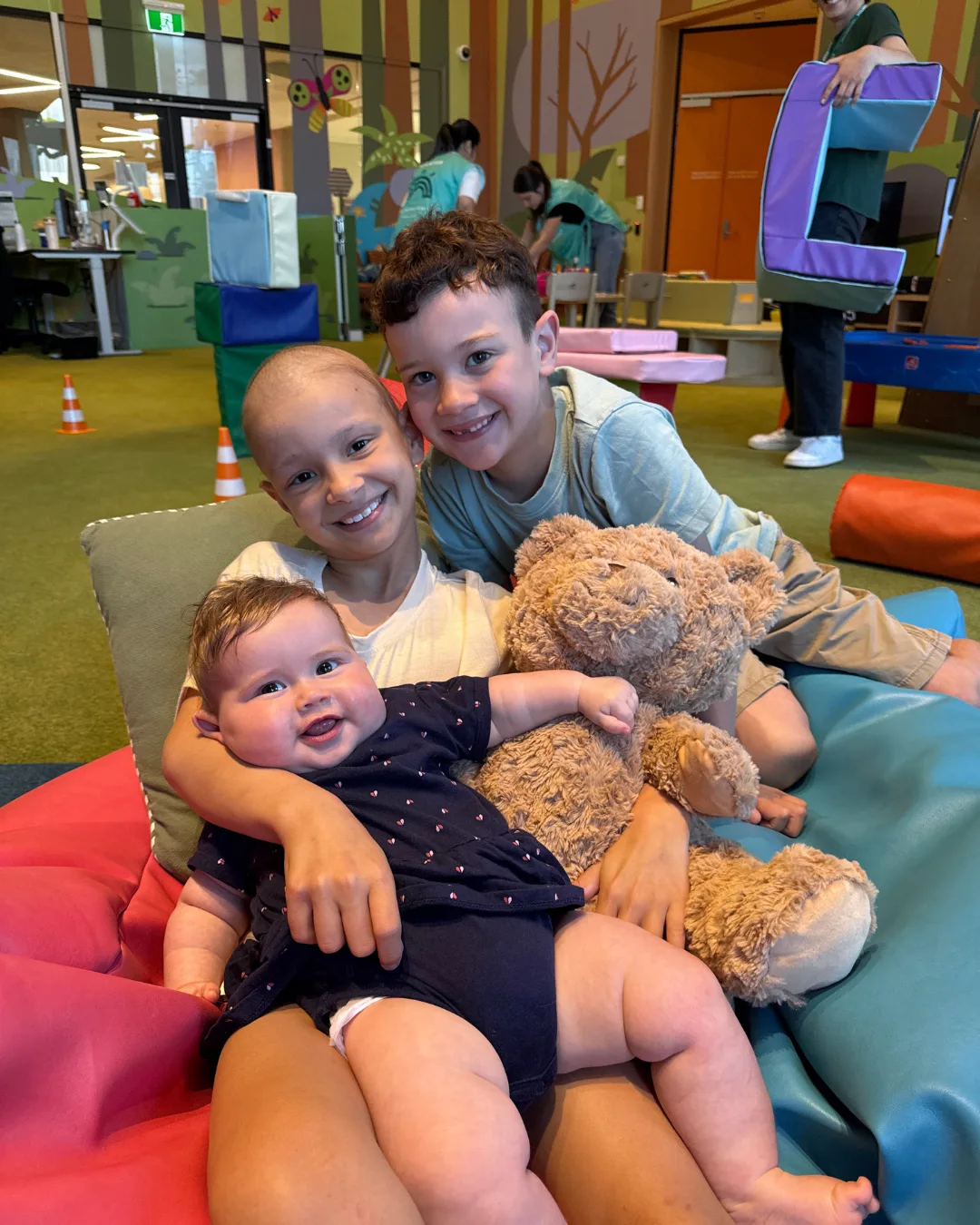 siblings cuddling on bean bags