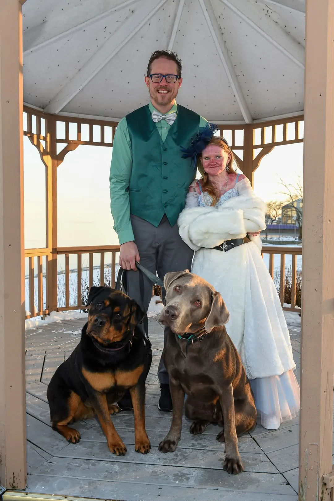 couple with dogs on wedding day