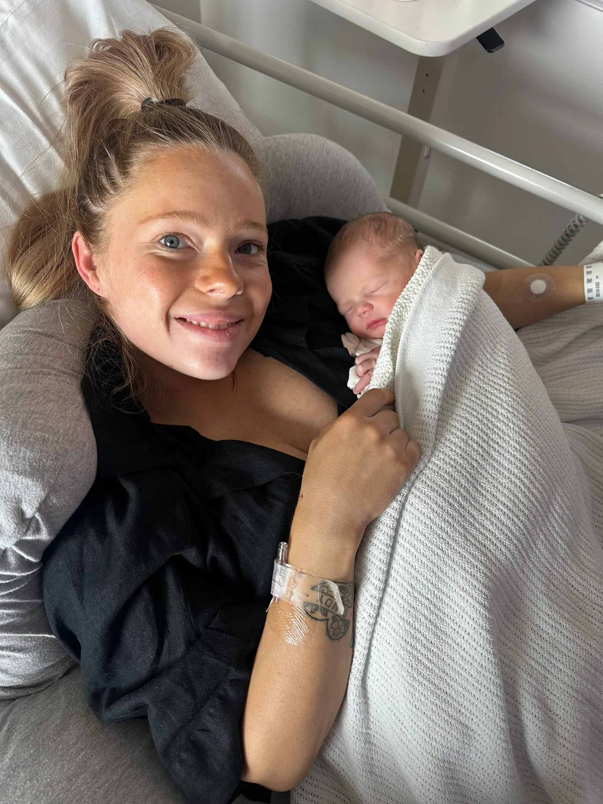 woman cuddling baby in hospital