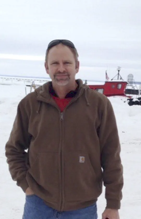 man in brown jacket in snow
