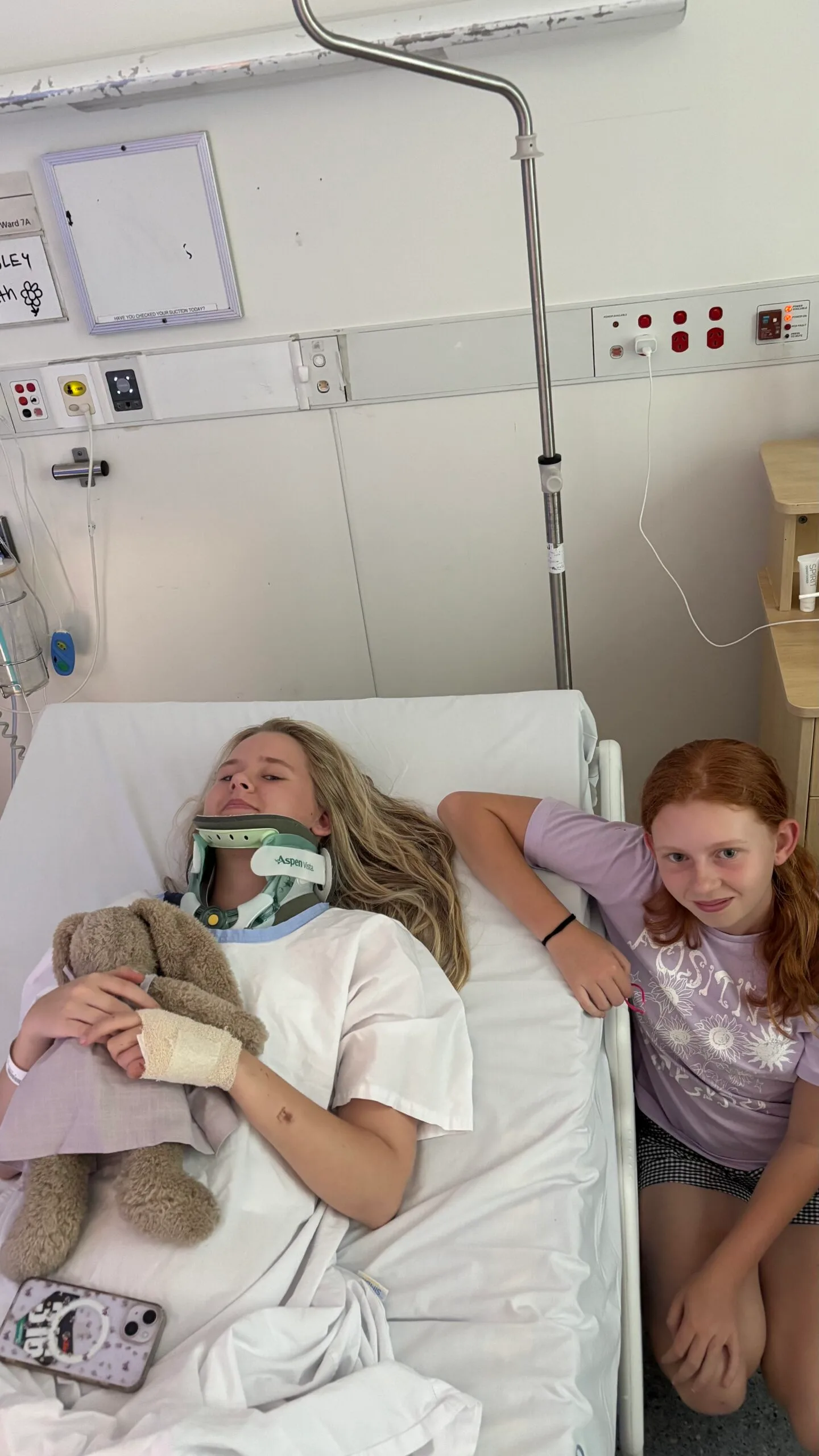 girl in hospital bed sister visiting