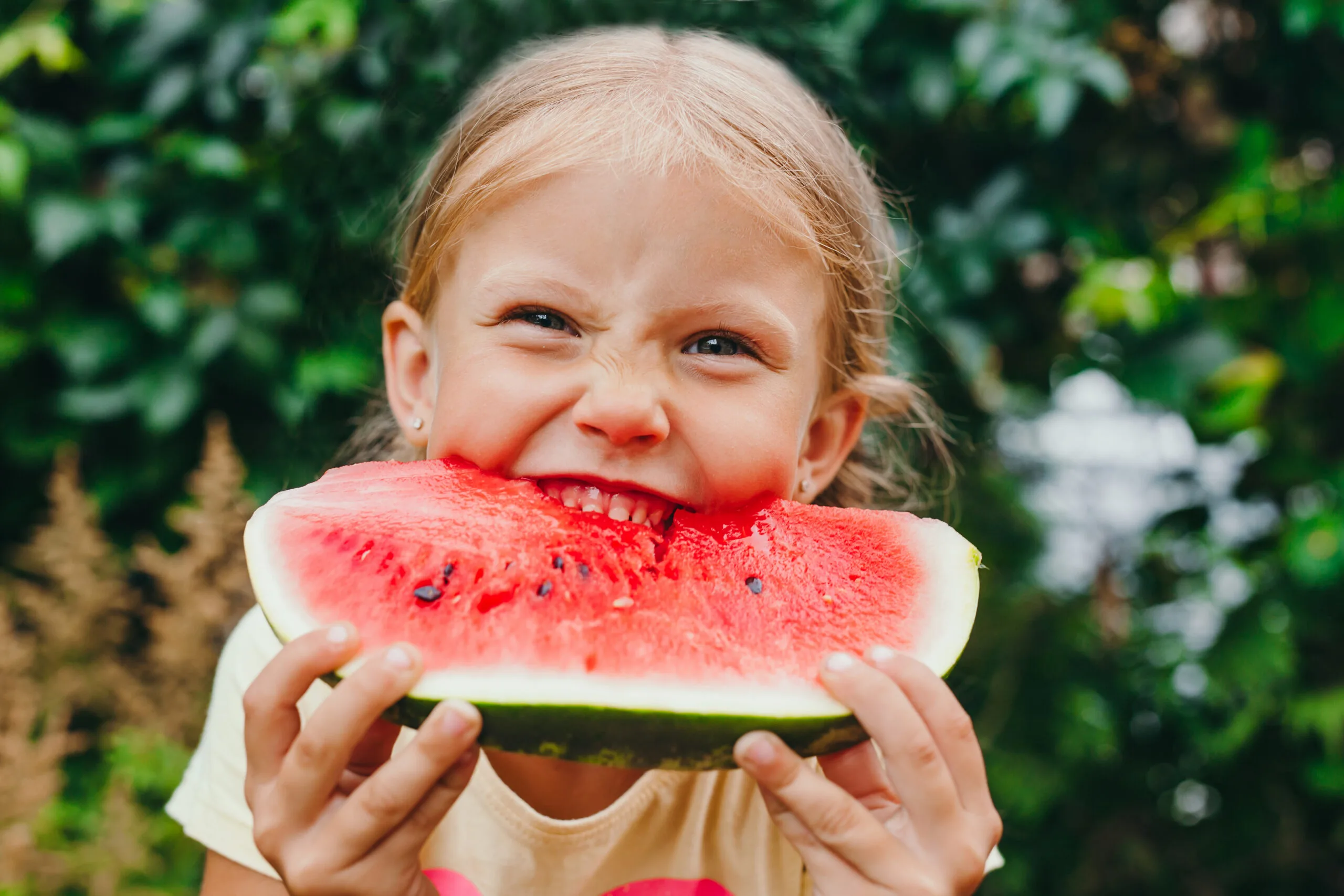 Young girl eating watermelon.