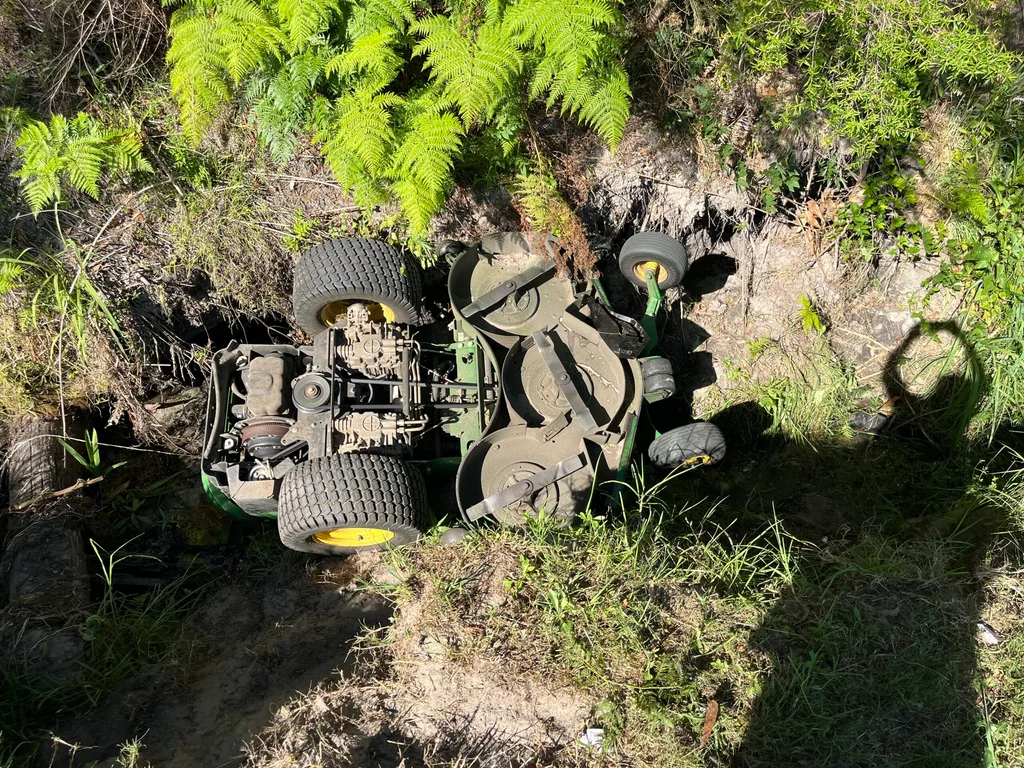 Image of ride on mower trapped in creek