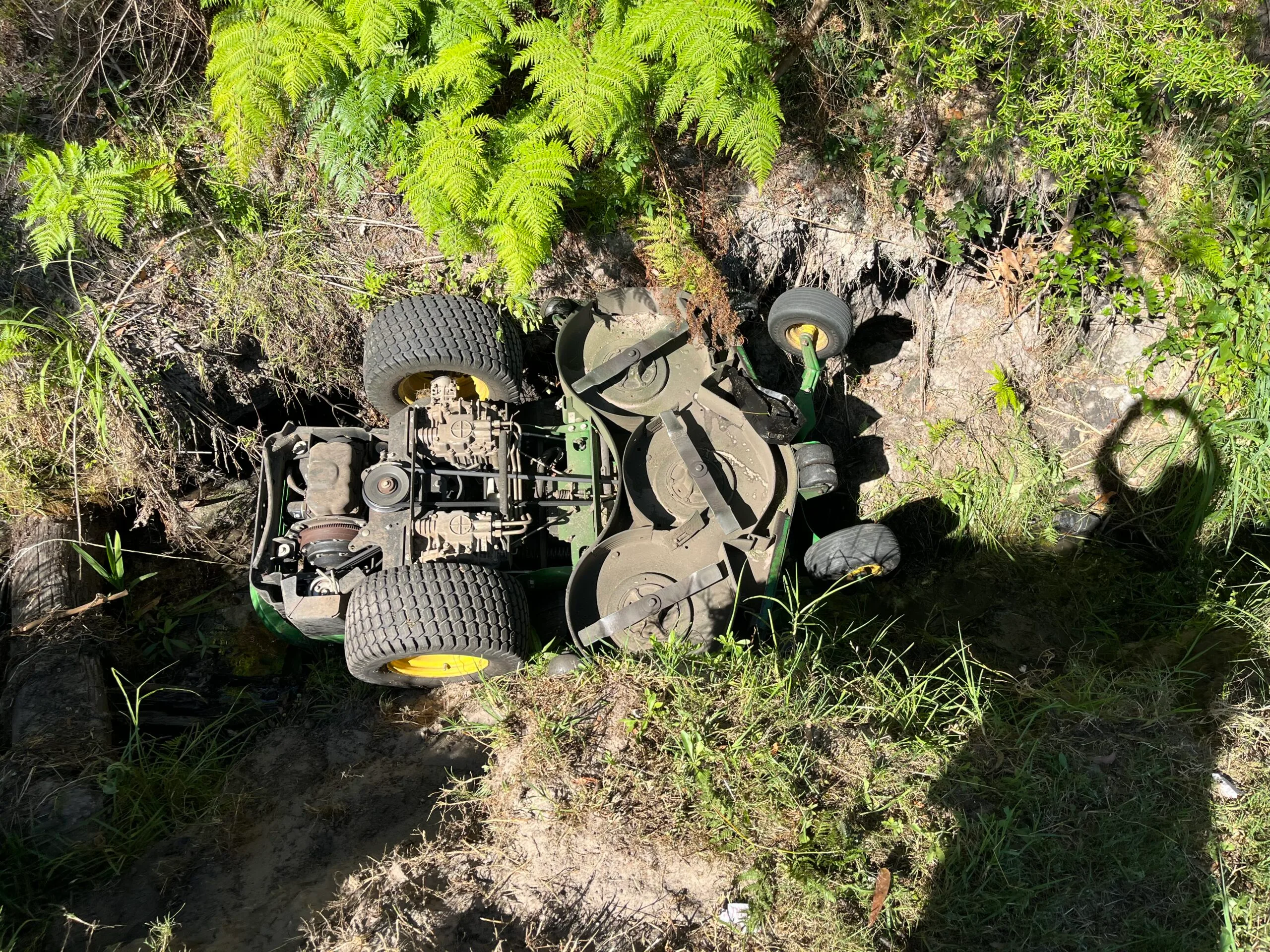 Image of ride on mower trapped in creek