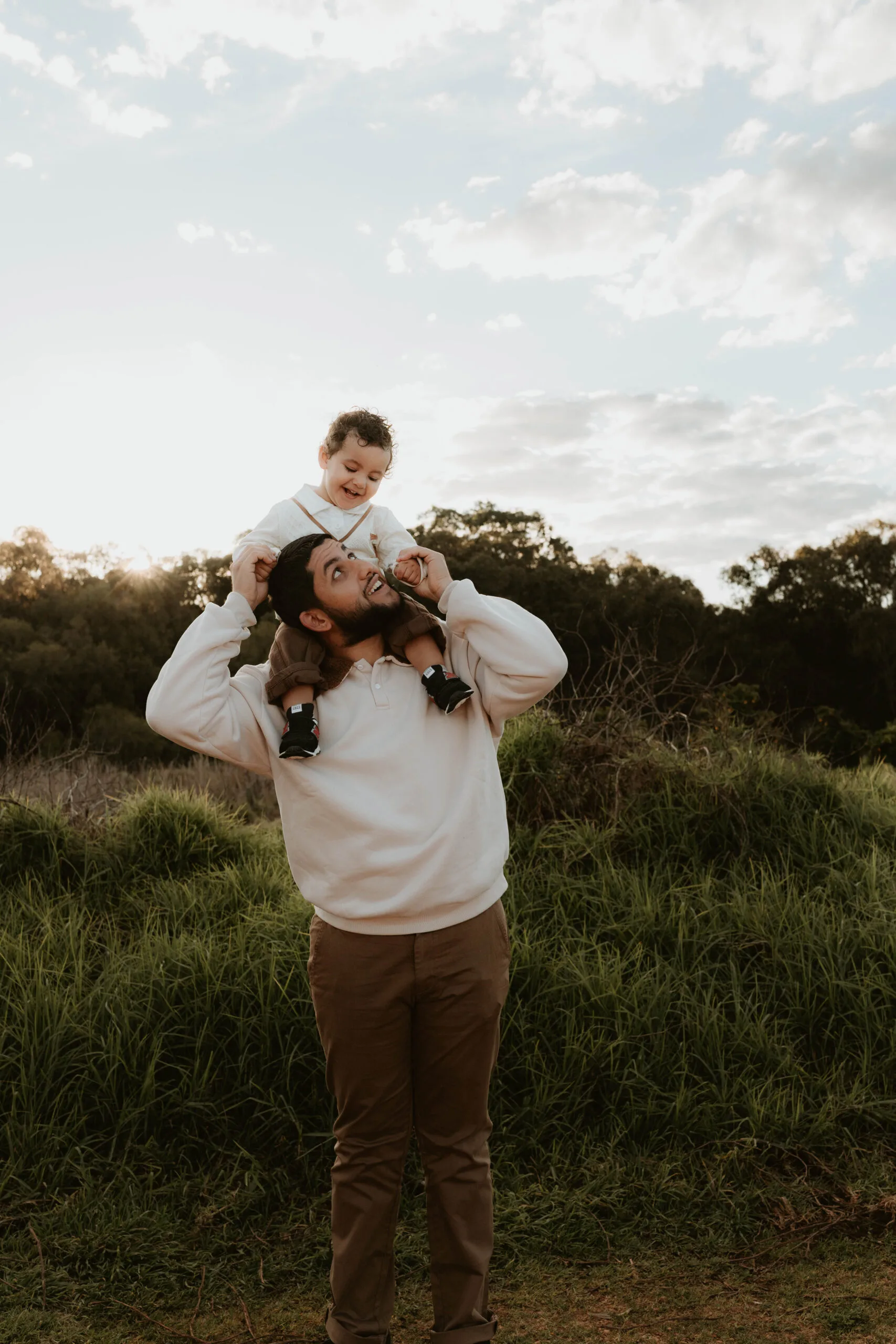son on fathers shoulders