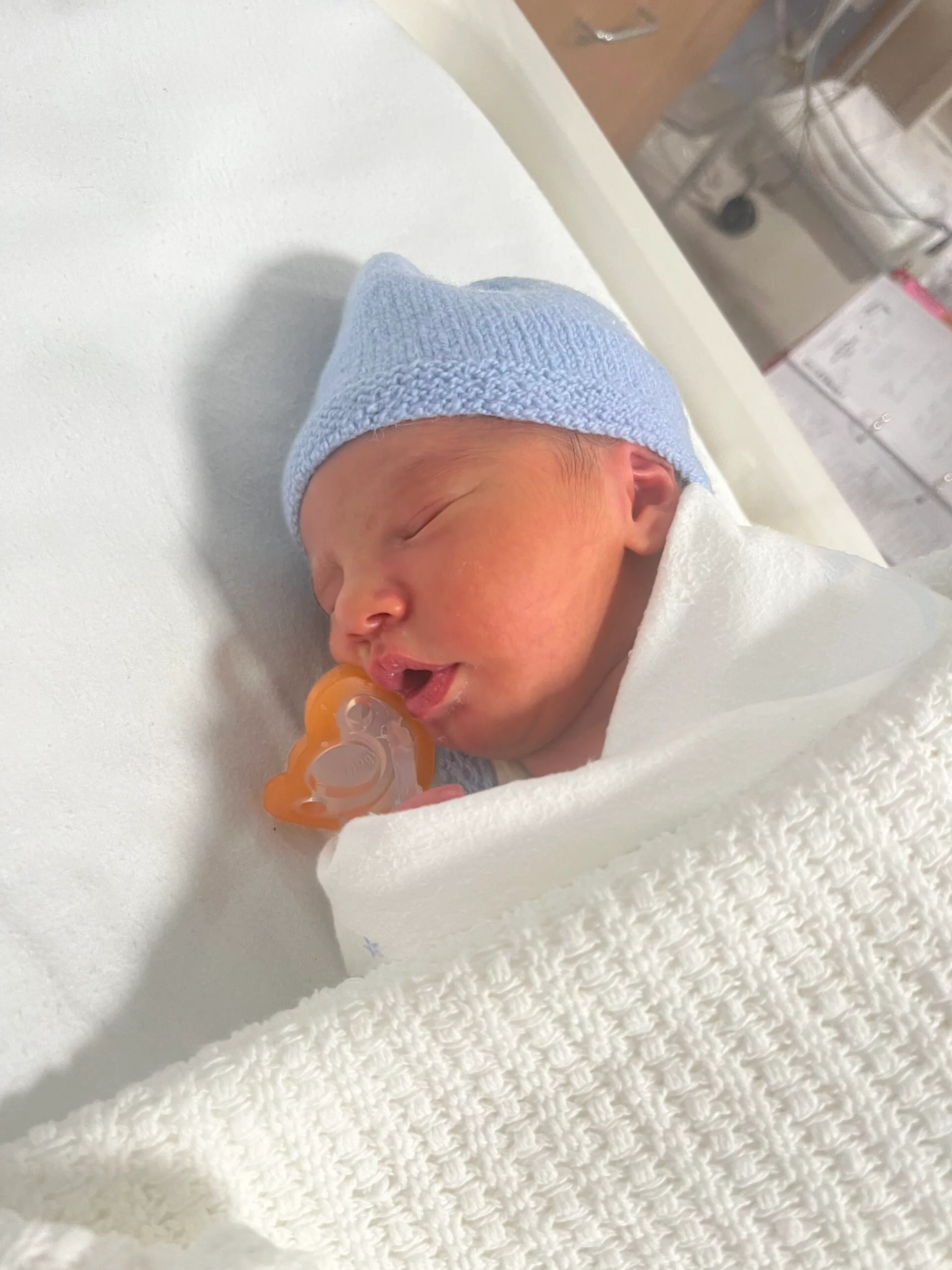 baby wrapped in white blanket