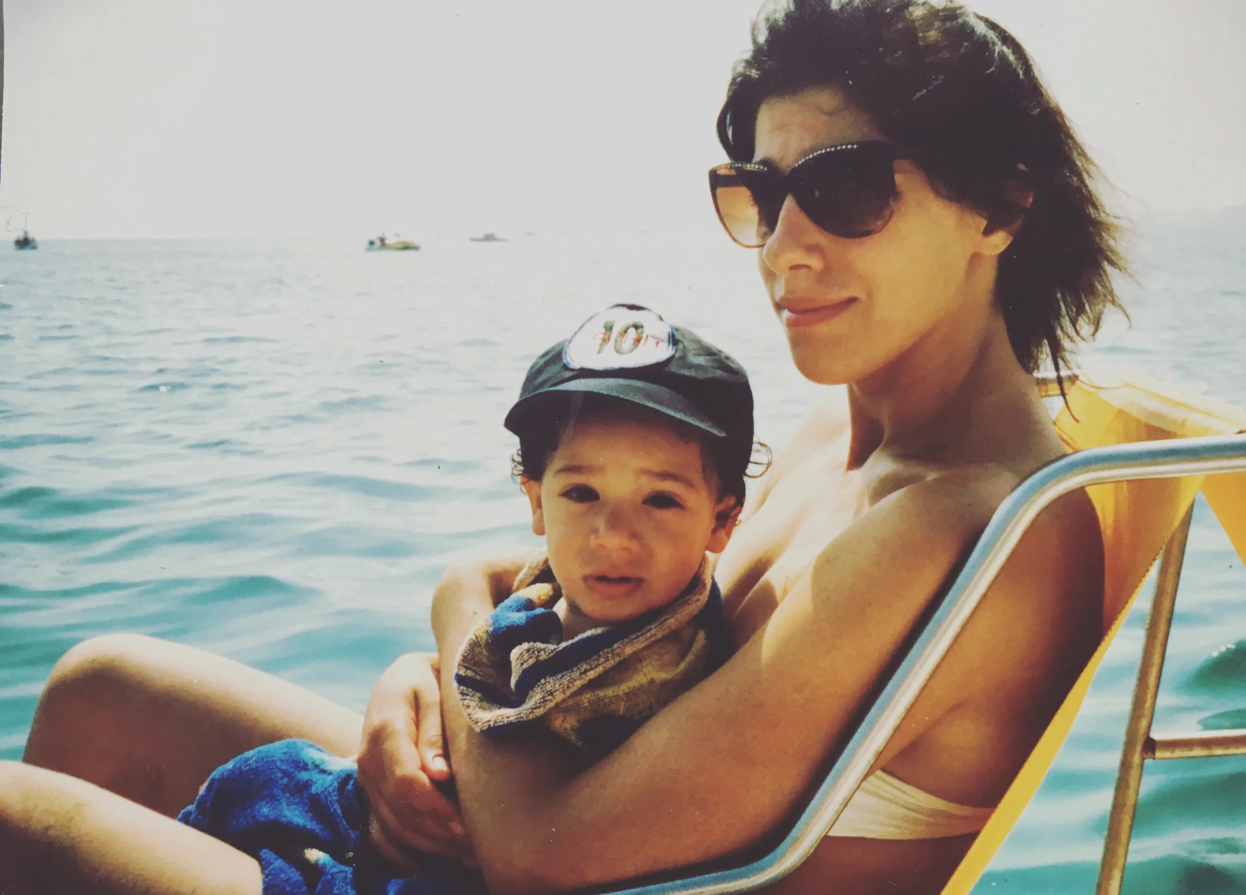 mum holding child by water