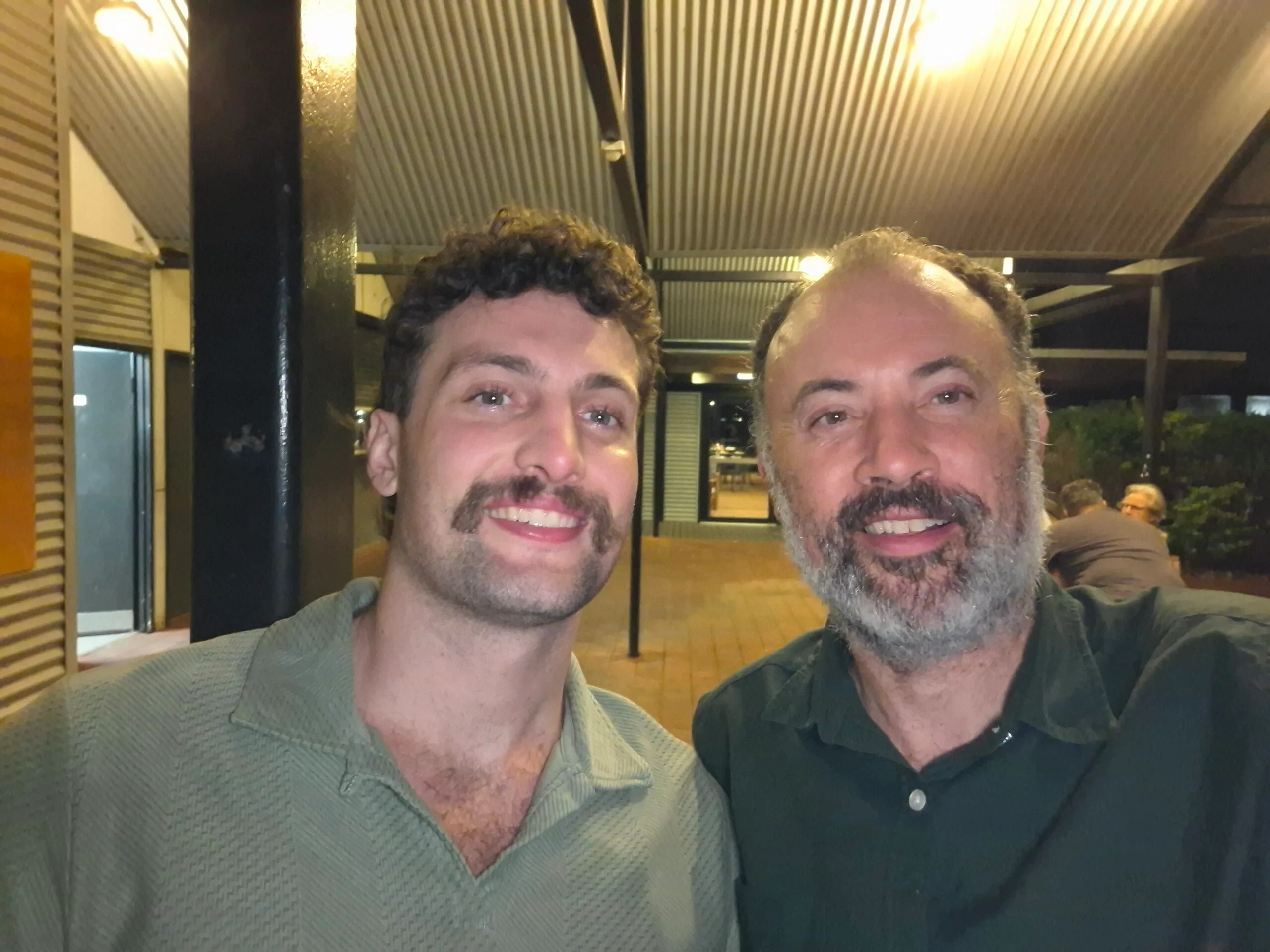 man and son in green shirts selfie