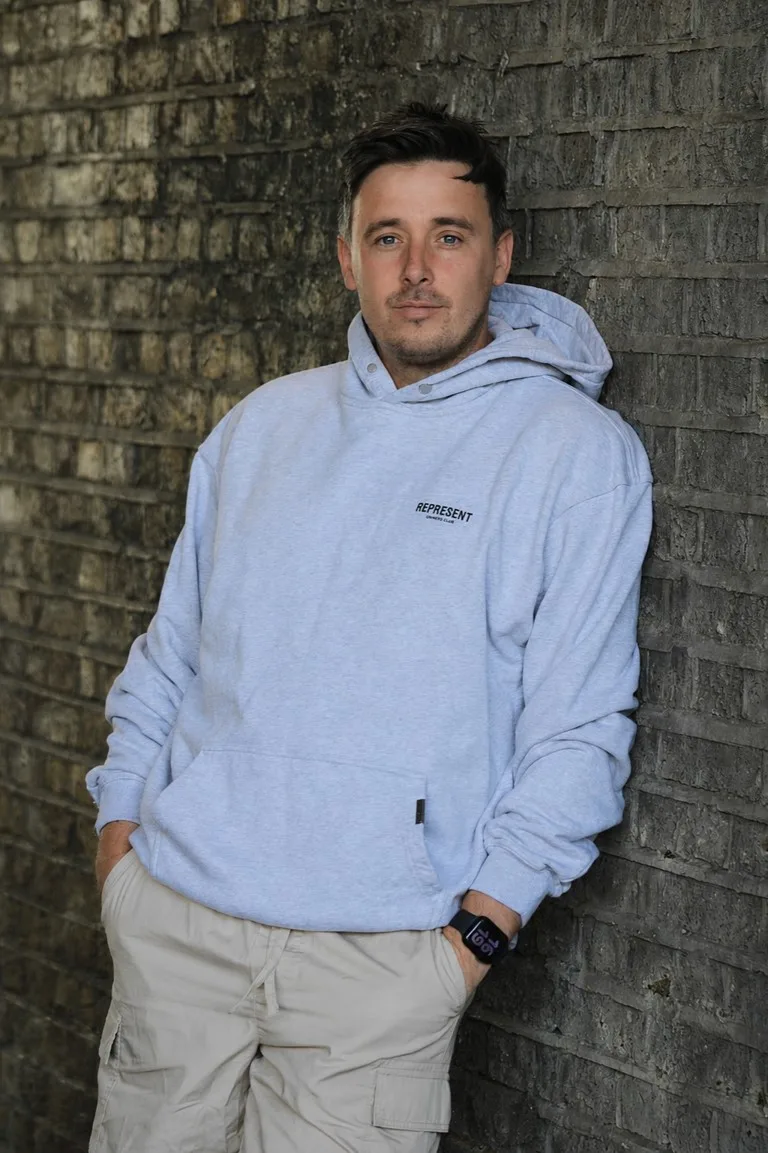 man leaning against wall