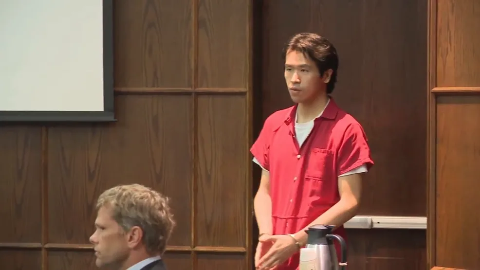 Image of murderer standing in court