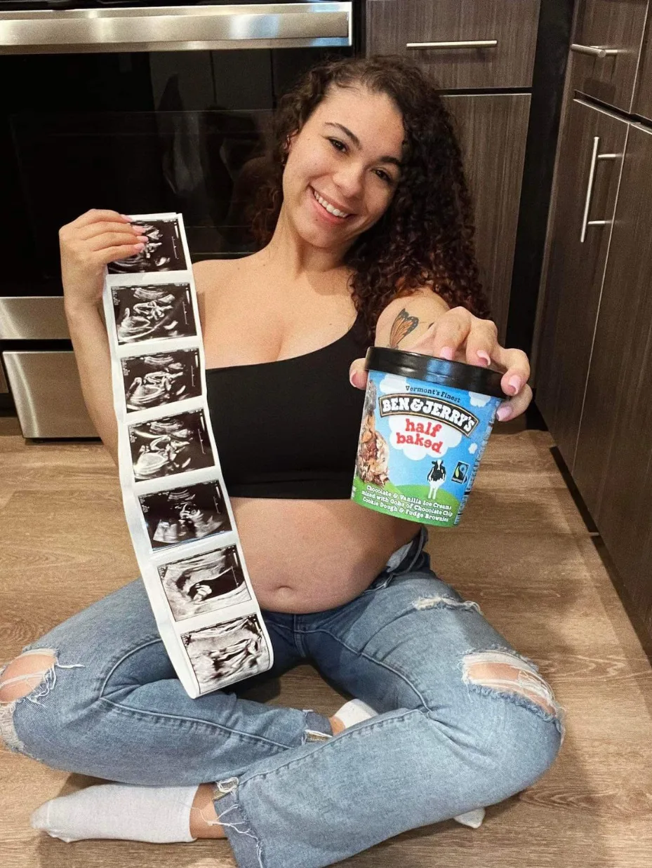 Woman, pregnant, holding up tub of icecream and ultrasound photo of baby.