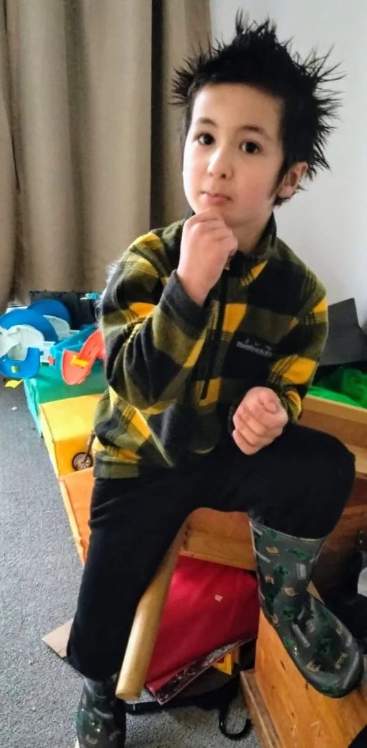 boy in yellow checked jacket