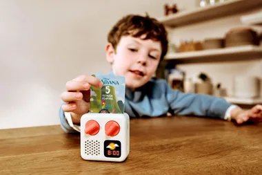 Boy plays with yoto player