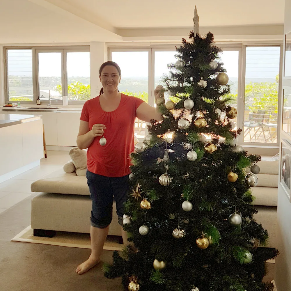 Layla Roberts decorating a client's Christmas tree