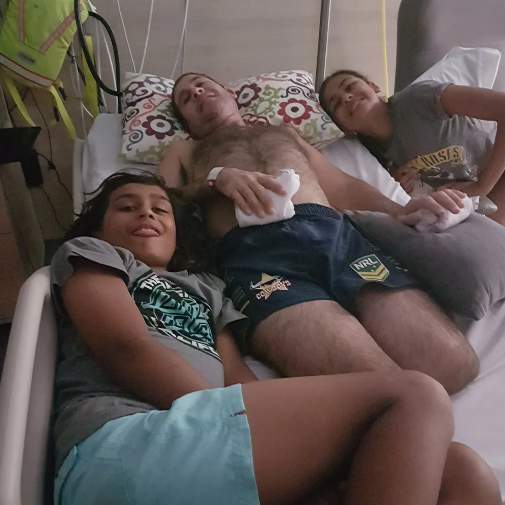 Jason with his children in hospital