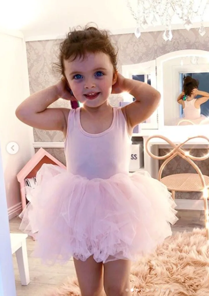 The pastel interior features a chandelier and bow chair