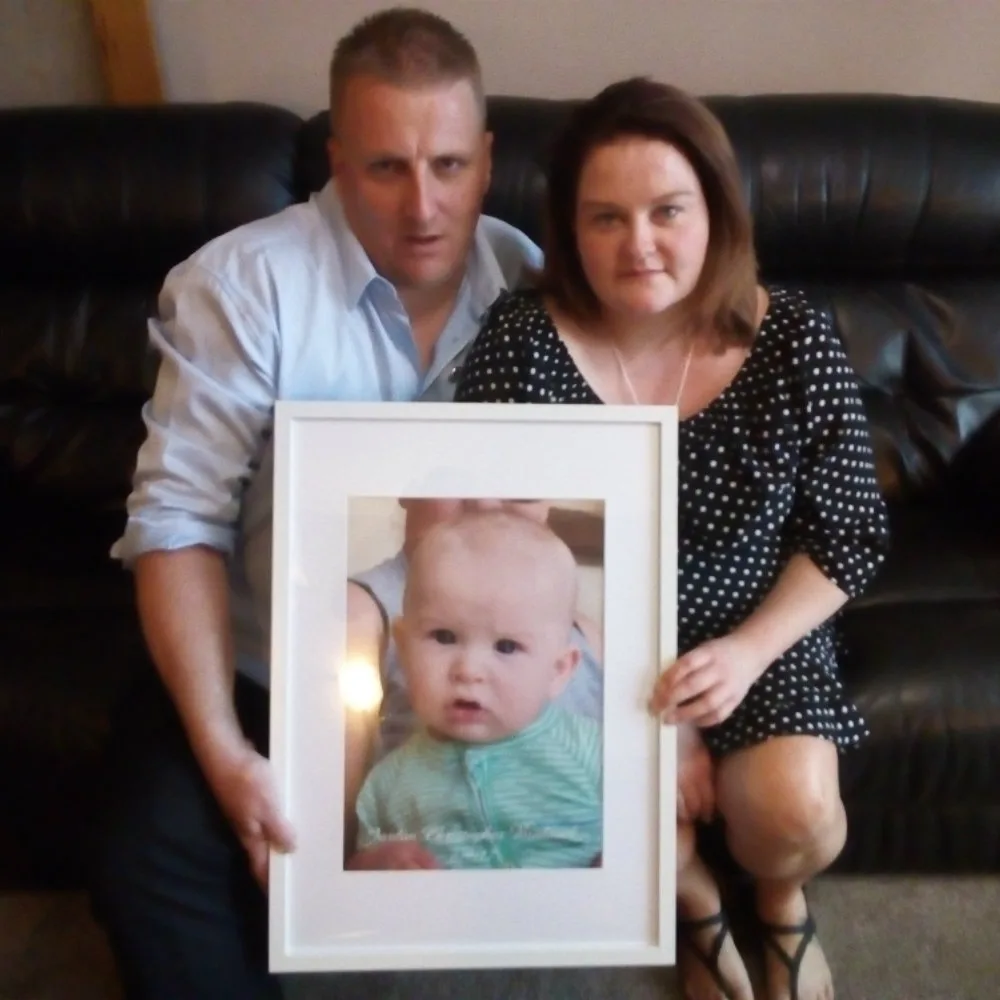 Nathan and Emma Braddock with a photo of their son Jordan
