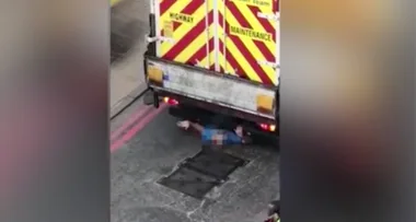 Strangers rescue man trapped under massive rubbish truck