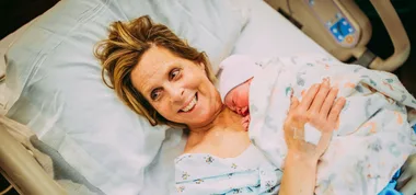 Cecile Eledge holds her granddaughter Uma after giving birth to her