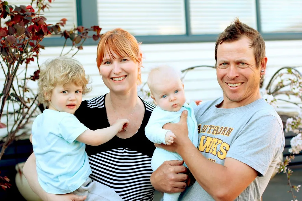 Vicky holding Mitchell, while husband holds Phoenix.