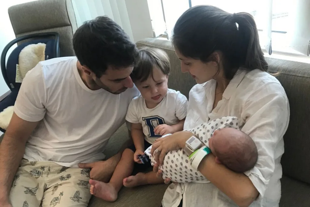 Charlie meeting his little sister Ruby. Credit: Supplied