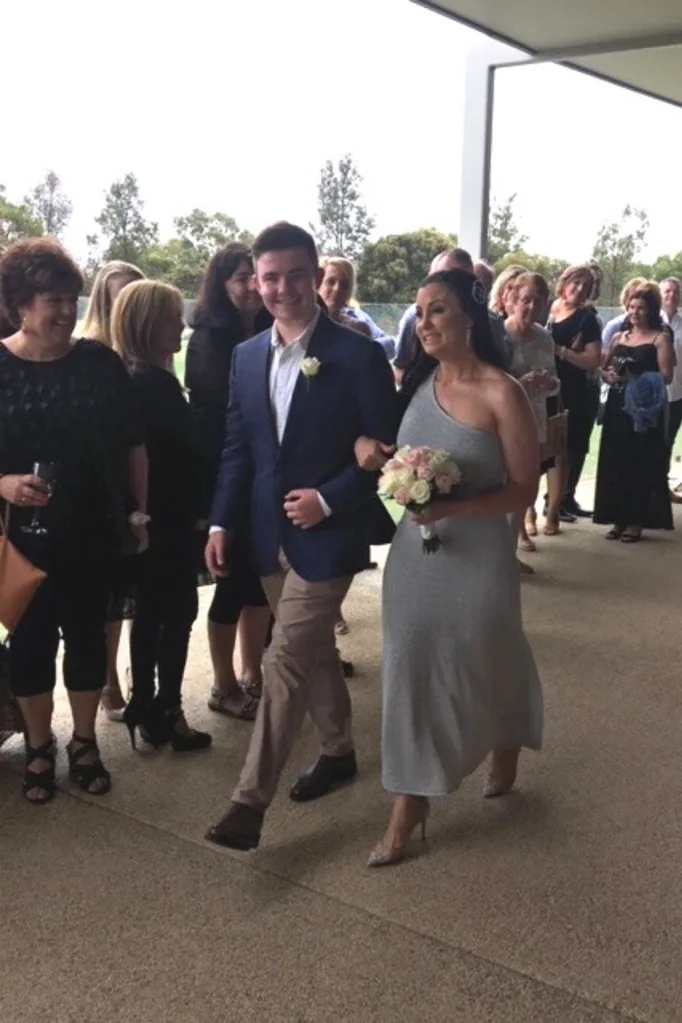 Zac walking his mum down the aisle.