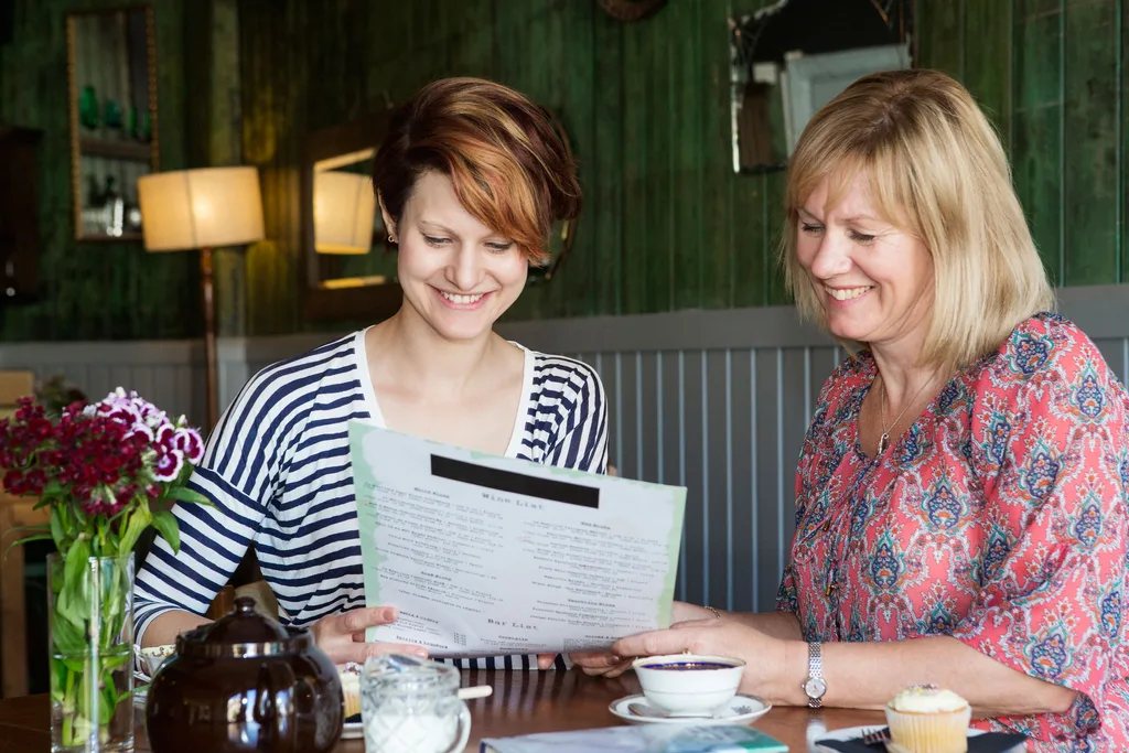 Mother and daughter ordering food at a restaurant.