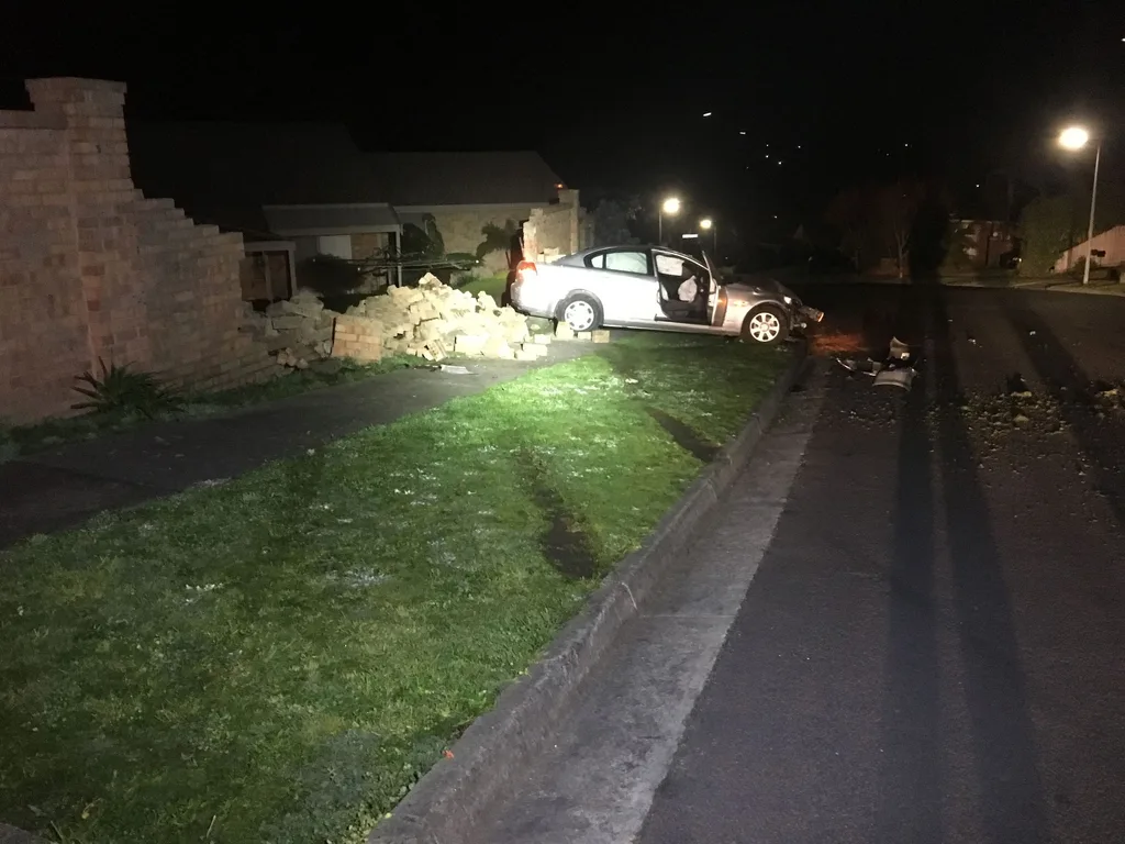 Holden Commodore crashed through wall St Helena disturbs bees