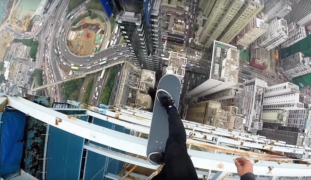 Cheung Jai balancing on his skateboard over the edge of a building.