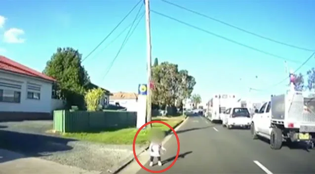 Toddler is standing in middle of the road as Gary pulls up