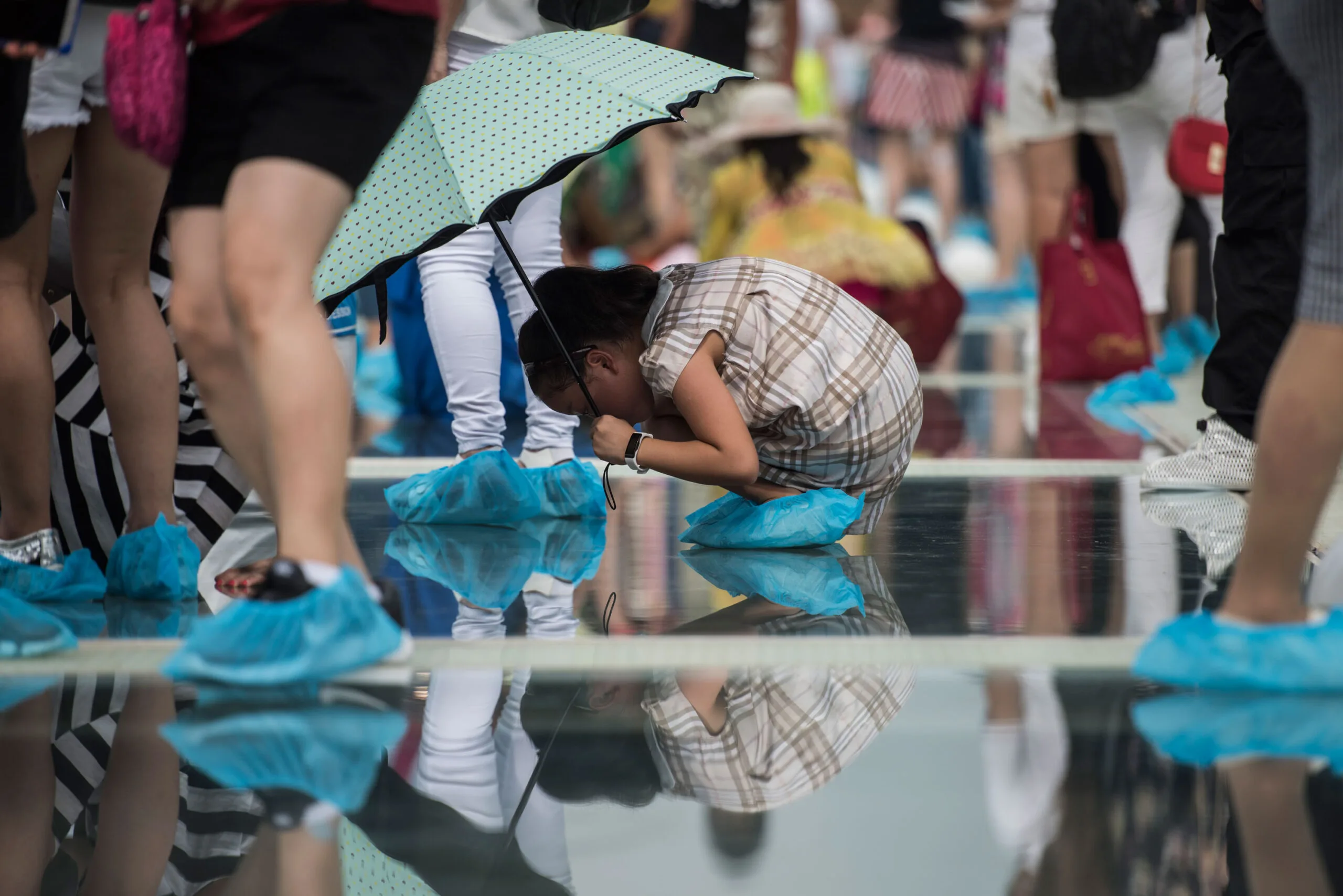 Woman looking through China's glass-bottomed bridge