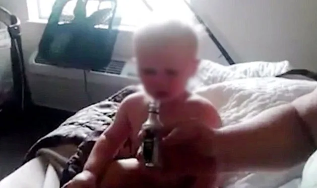 Baby being offered american honey liquor