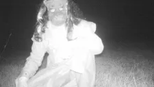 man in costume takes photo