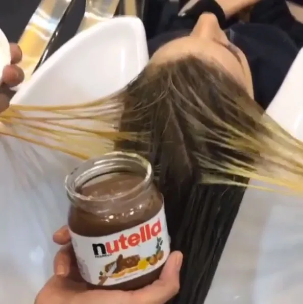 Nutella is dolloped through her hair.