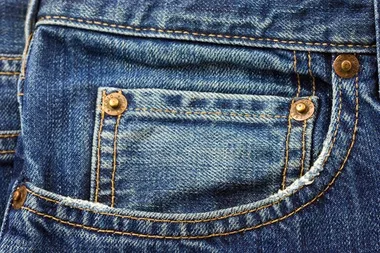 The reason your jean pockets have tiny buttons on them