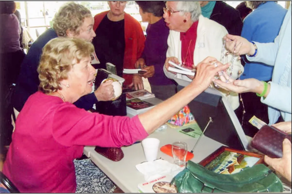 Doreen signing books after giving a talk