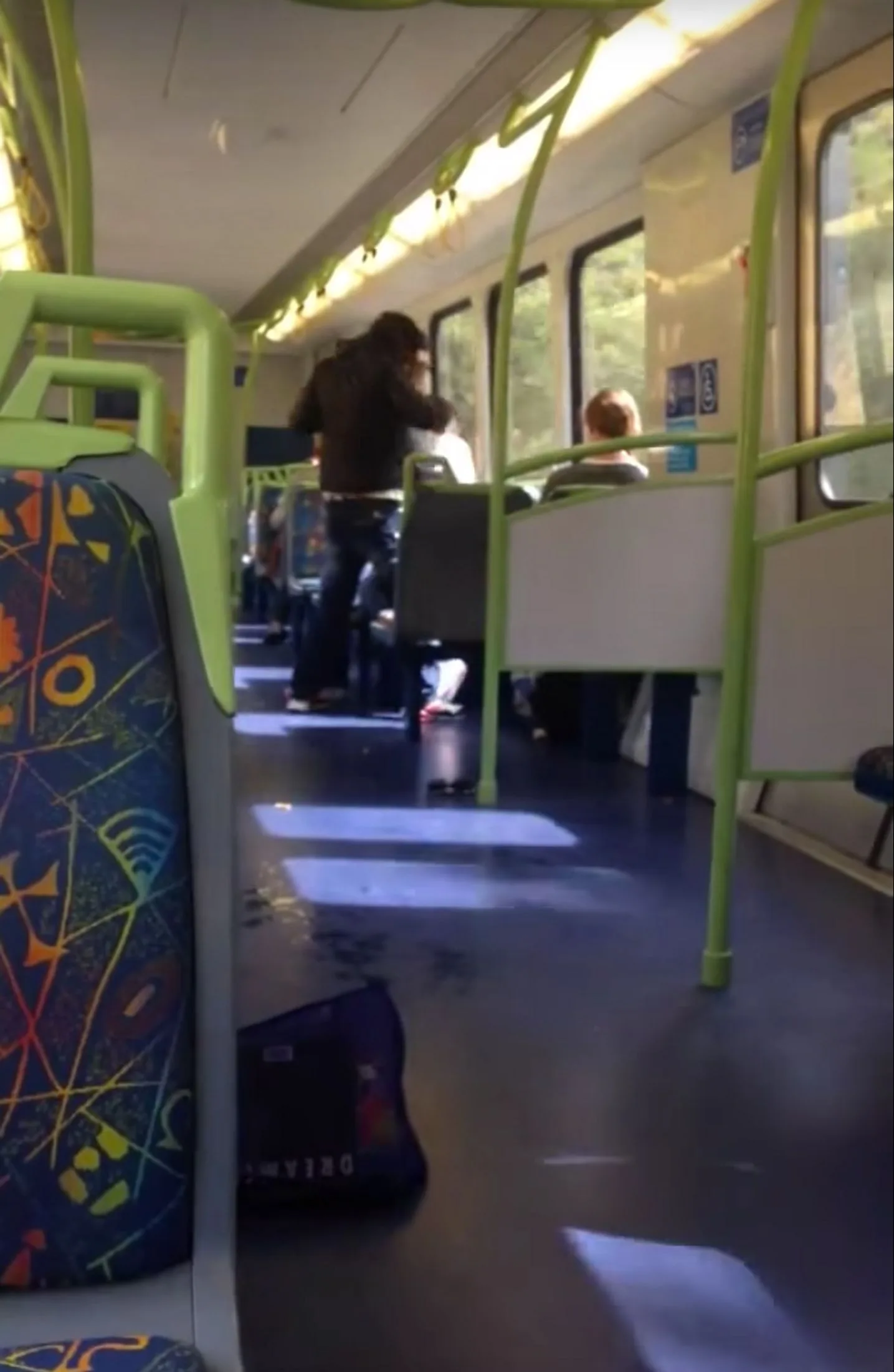 One woman is wrestled into a passenger seat