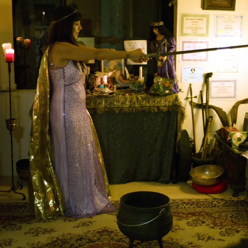 Mara Carter, a real life witch from Hornsby, casts spells with her wand and cauldron
