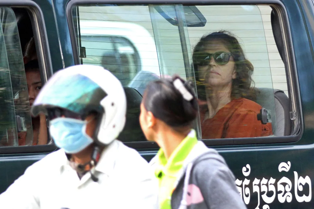 Australian national Tammy Davis-Charles (R), 49, sits in a prison car as she travels to Phnom Penh municipal court on June 13, 2017.