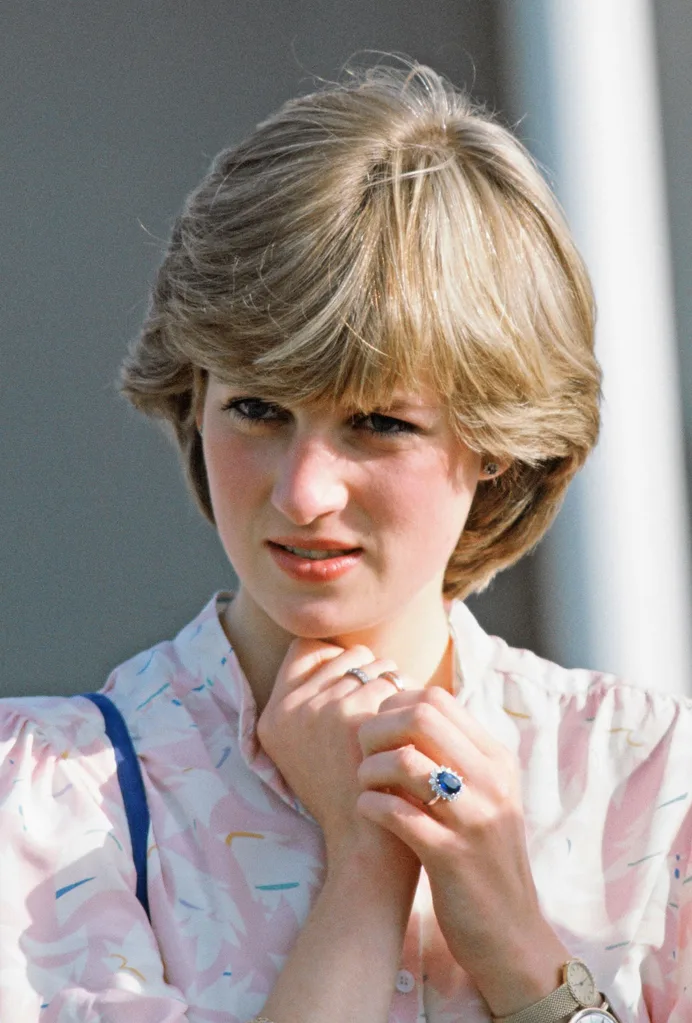 Diana watches Charles play polo while wearing two watches.