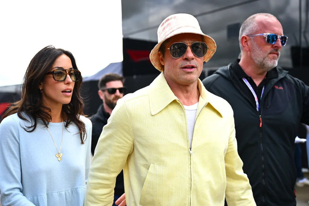 NORTHAMPTON, ENGLAND - JULY 07: Brad Pitt, star of the upcoming Formula One based movie, F1, and Ines de Ramon walk in the Paddock prior to the F1 Grand Prix of Great Britain at Silverstone Circuit on July 07, 2024 in Northampton, England.
