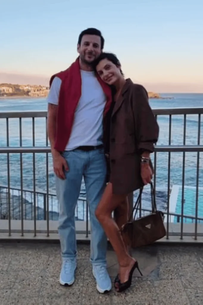 Domenica Calarco and her boyfriend posing together in front of Bondi Beach.
