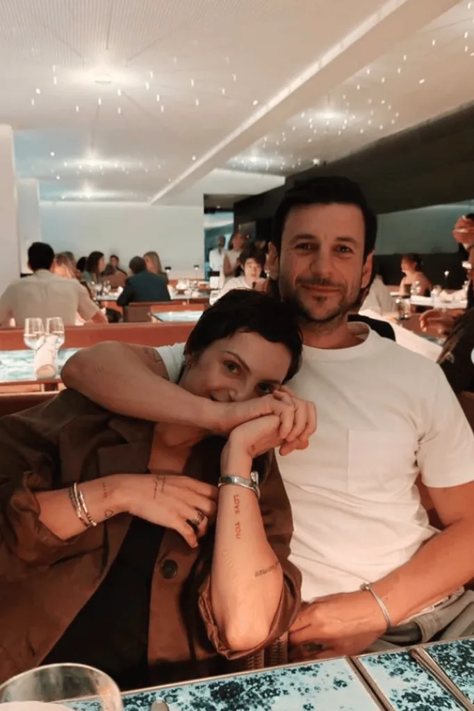 Domenica Calarco sitting next to her boyfriend at a restaurant table.