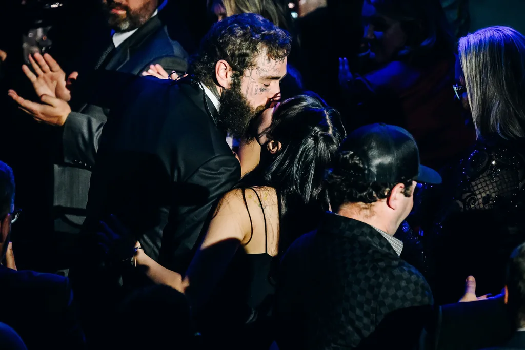 Post Malone kissing his fiance Jamie.