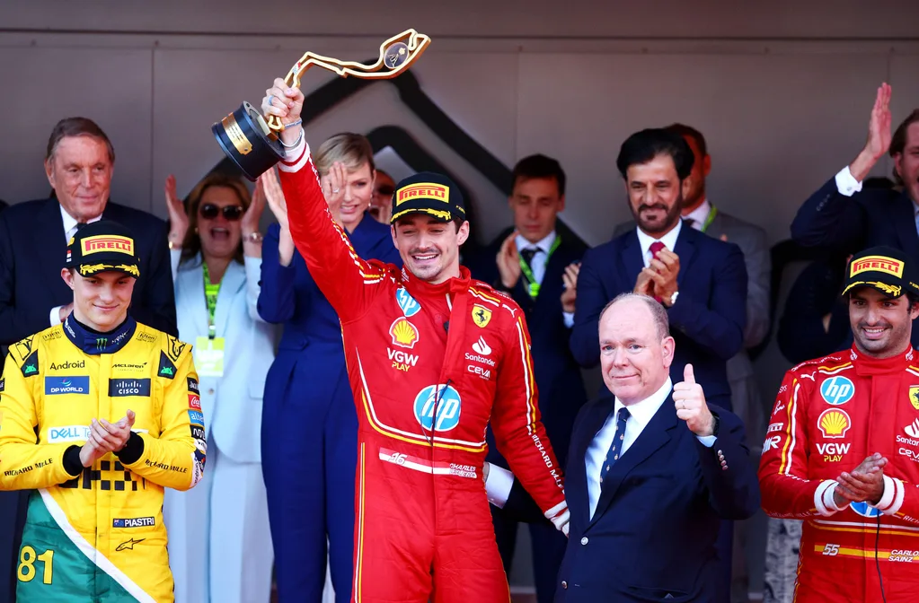 MONTE-CARLO, MONACO - MAY 26: Race winner Charles Leclerc of Monaco and Ferrari celebrates with Prince Albert of Monaco on the podium during the F1 Grand Prix of Monaco at Circuit de Monaco on May 26, 2024 in Monte-Carlo, Monaco. (Photo by Clive Rose/Getty Images)
